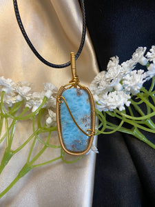 light blue, dark blue, white and grey rectangle larimar pendant with looped wire detailing. 